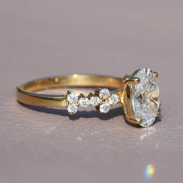 Stylishly crafted this unique oval and round cut diamond ring in 14 kt yellow gold lab grown diamonds Gurukrupa-Gems